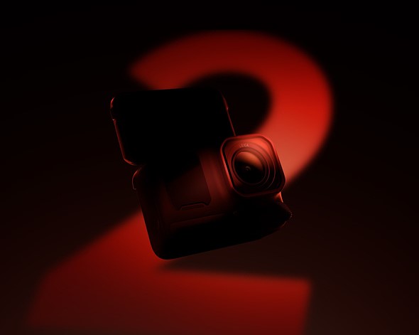Image of an action camera floating against a black background with its screen flipped up. A red 2 is cast onto it in light.