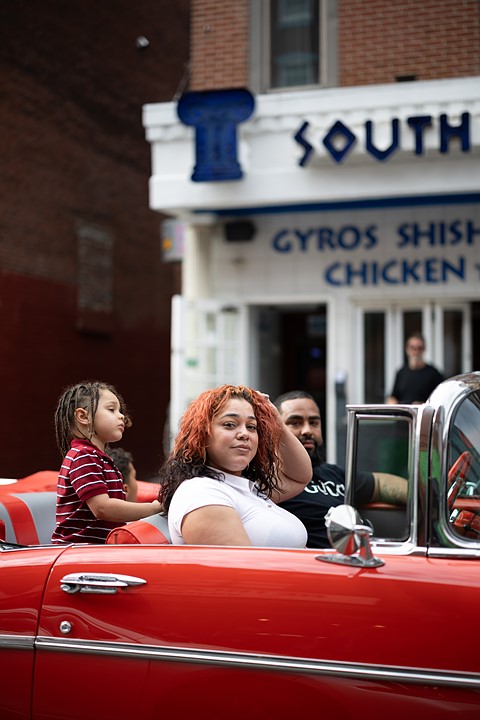 Portrait by South Street Sam - woman in red convertible