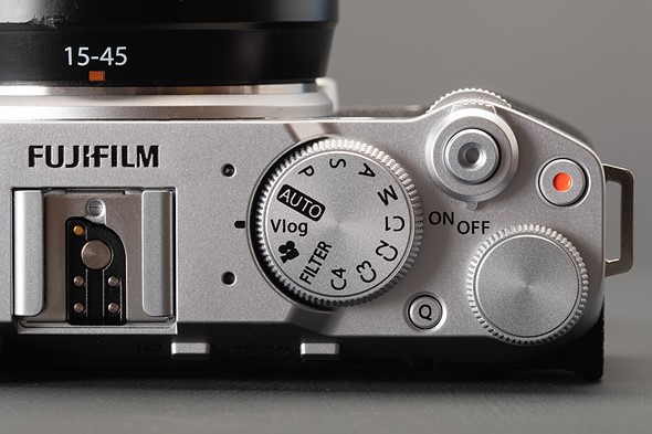 Picture showing the X-M5's control dial, mode dial, shutter button, record button, and Q button.