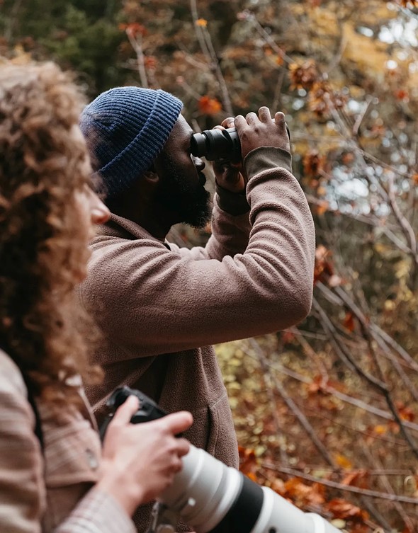 Man-holding-fujifilm-binoculars