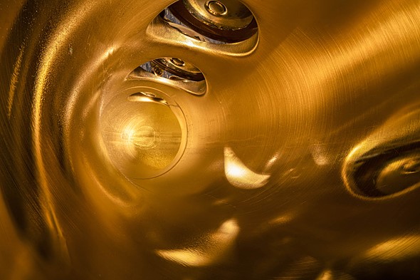 inside a gold saxaphone with glowing light