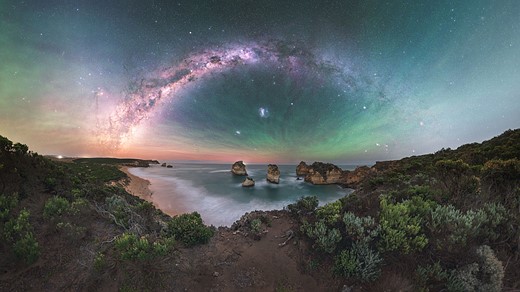 milky way stretches above beach scene