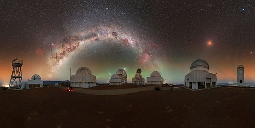 milky way stretches above observatories in chile