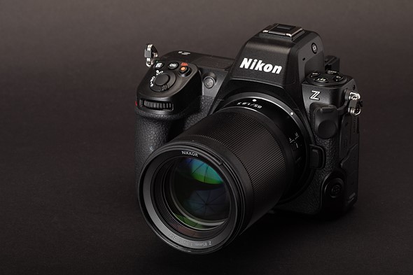 Photo of the Nikon Z8 with an 85mm lens attached against a black background