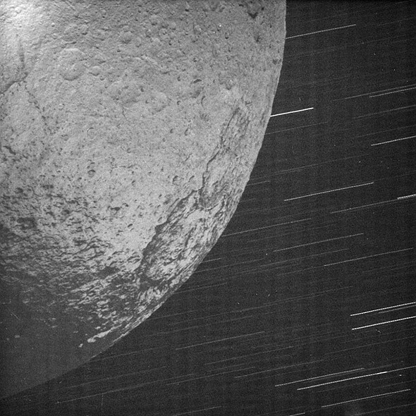 The night side of Saturn’s distant moon Iapetus  912 mile photographed in Saturn-light