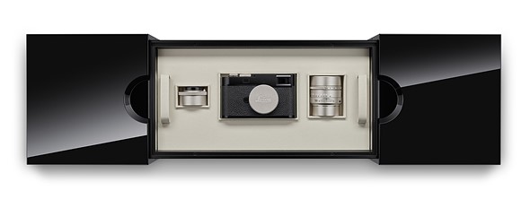 a glossy box with leica camera and two lenses is placed on a white background