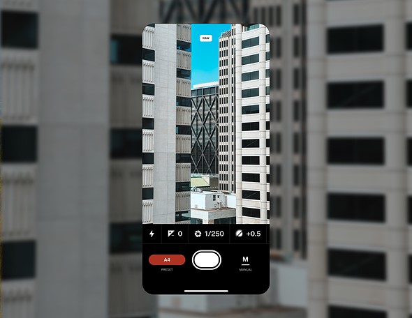 a screenshot of a phone with the vsco capture app is placed against a cityscape