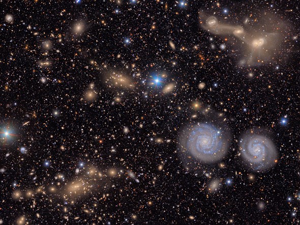 a swirl of spiral galaxies are surrounded by scolorful stars