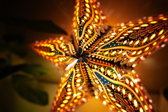 warm light glows from a yellow star shaped light with blue accents