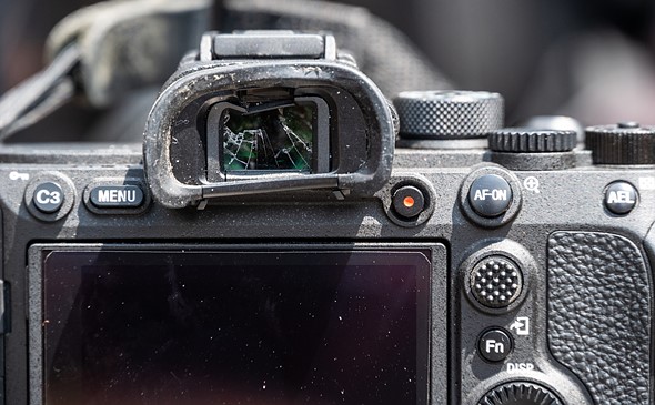 a camera has a broken and muddy viewfinder