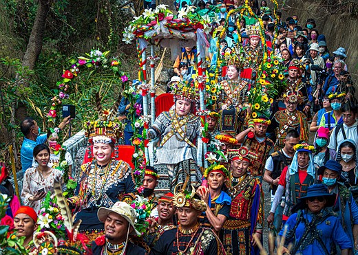 a group wearing colorful clothes smiles while progressing down a path