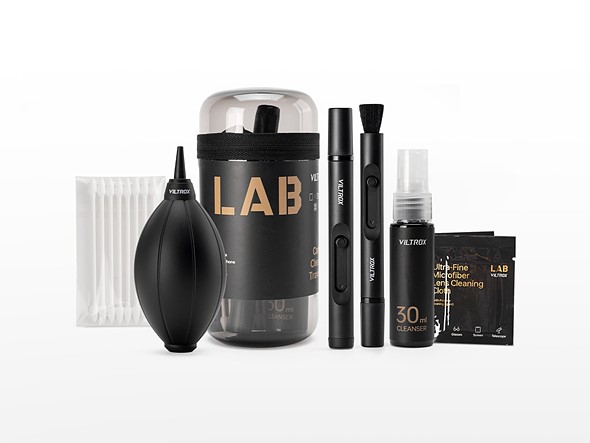 a selection of black lens cleaning tools are placed standing on a white background