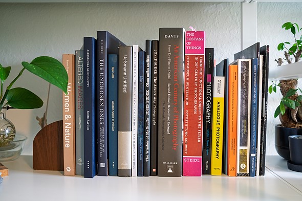 books are placed neatly on a white bookshelf
