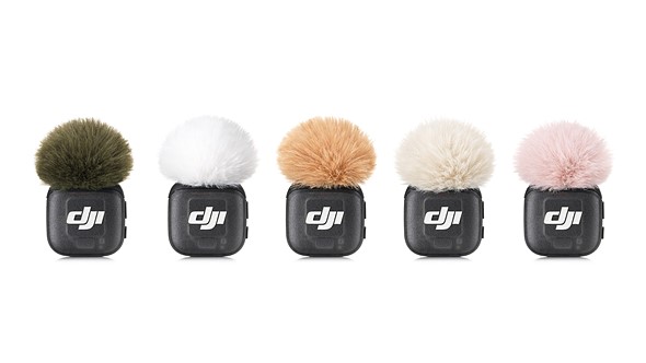 five small dji mics are lined up with different color windscreens while on a white background