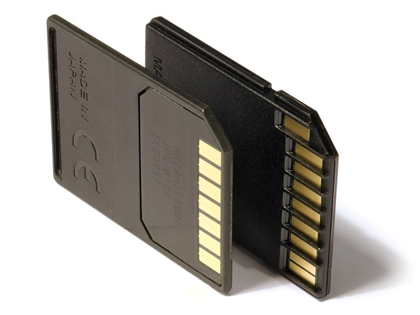 two memory cards are placed on their edges to stand up on a white background