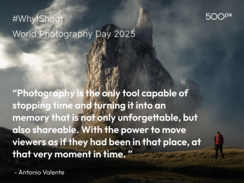 World Photography Day 2025 quote graphic featuring a dramatic mountain peak shrouded in mist with a lone hiker in a red jacket, paired with Antonio Valente’s quote: ‘Photography is the only tool capable of stopping time and turning it into an memory that is not only unforgettable, but also shareable. With the power to move viewers as if they had been in that place, at that very moment in time.’
