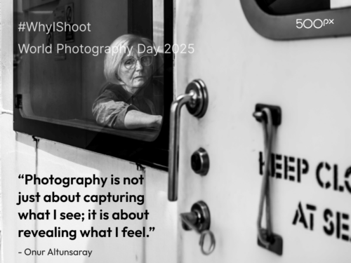 World Photography Day 2025 quote graphic featuring a black and white photo of an elderly woman with glasses looking out from a window, accompanied by Onur Altunsaray’s quote: ‘Photography is not just about capturing what I see; it is about revealing what I feel.’