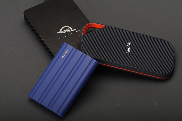 three-portable-ssds are on a black background