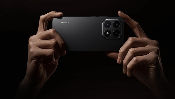 two hands hold the xiaomi 15t against a black background