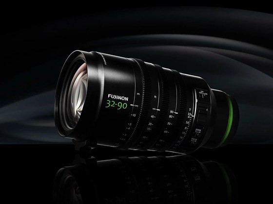 a fujinon lens sits against a black background in dramatic lighting