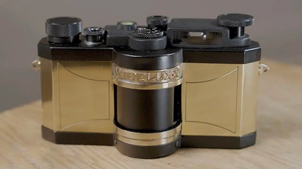 a gold WideluxX prototype 0001 sits on a desk