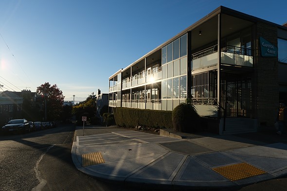 a sixties-style apartment building catches the sun