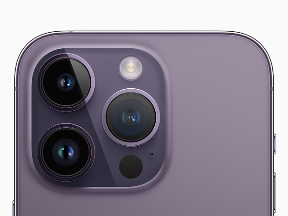 an Apple marketing image showing the back of a lavender colored iPhone 14 Pro and its triple camera array