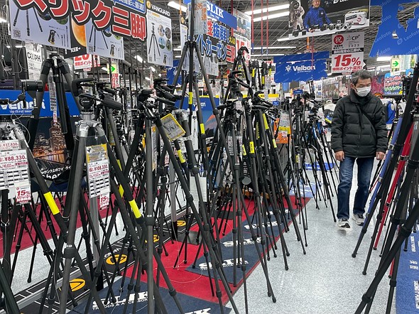 dozens of tripods stand in the camera section of Yodobashi Camera in Tokyo