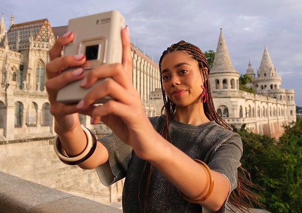 person taking selfie withinstax liplay plus