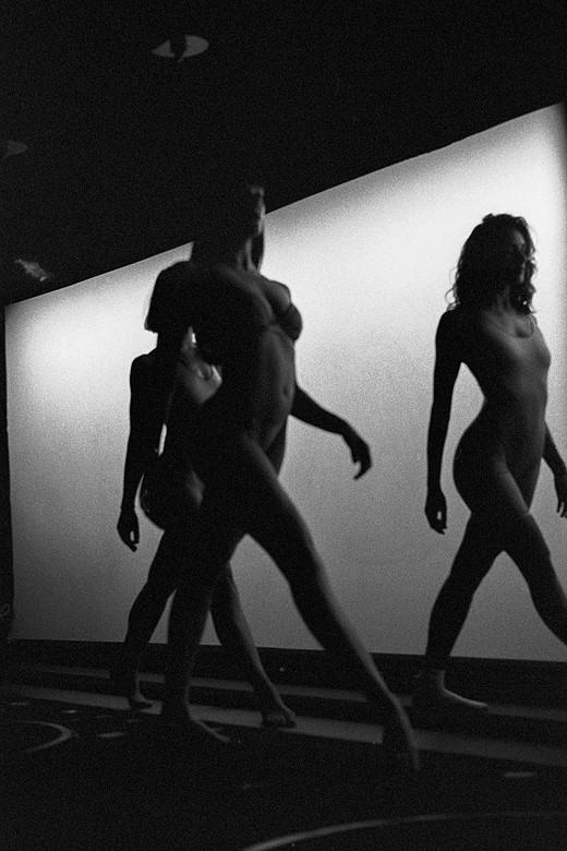 three female models stride across a runway