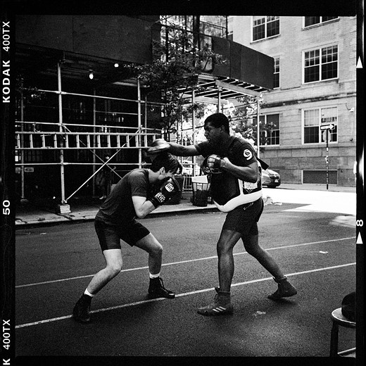 two boxers spar in a street