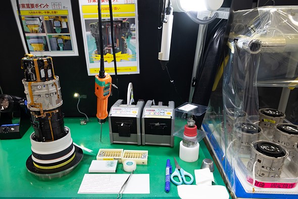 A workstation with a partially-assembled 100-300 lens
