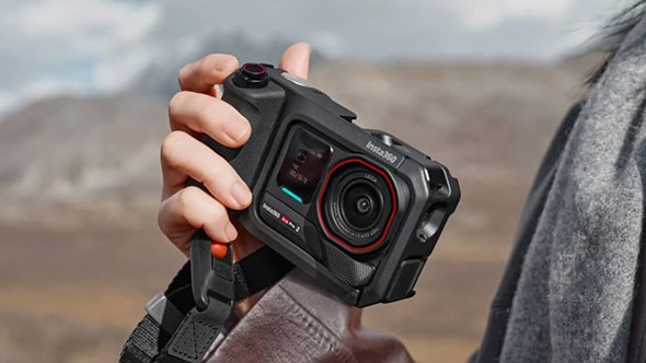 a hand holds the insta360 ace pro 2 with pro grip