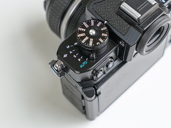 a nikon camera is on a white desk