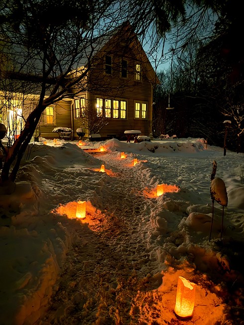 howard crysta glowingl snow front yard of house at night