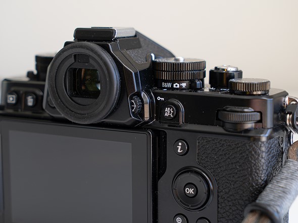 a black camera sits against a white background