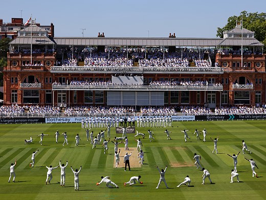 cricket players stretch and warm up in front of stands