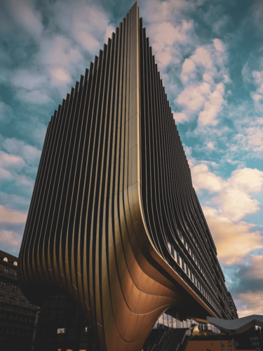 Silhouette of a child running along the shoreline at sunset, capturing motion and light as part of ongoing photography improvement.