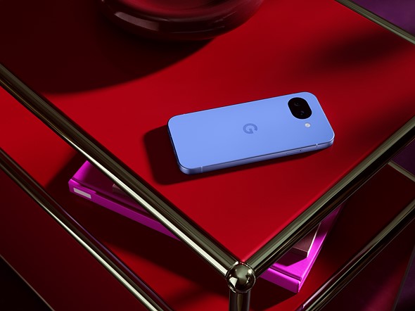 a blue phone sits on a bright red coffee table