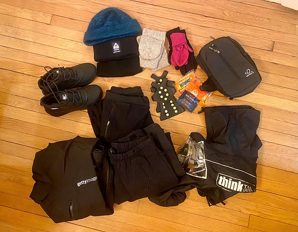 a selection of clothing items are laid out on a wood floor