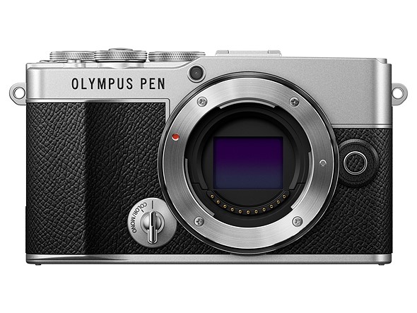 a black and silver olympus pen camera is on a white background