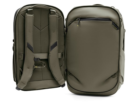 two green backpacks are standing next to each other on a white background