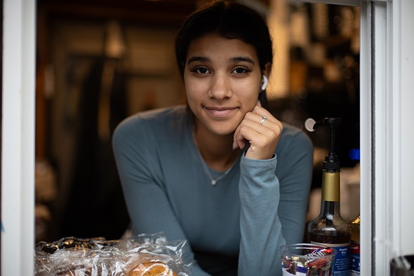 a portrait of a woman looking out through a window