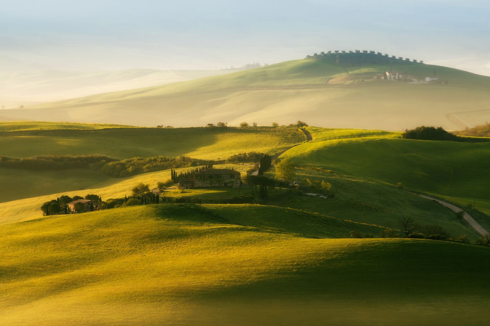 Rolling hills in Tuscany at golden hour by Pawe? Janas, landscape photography with soft light and layered depth