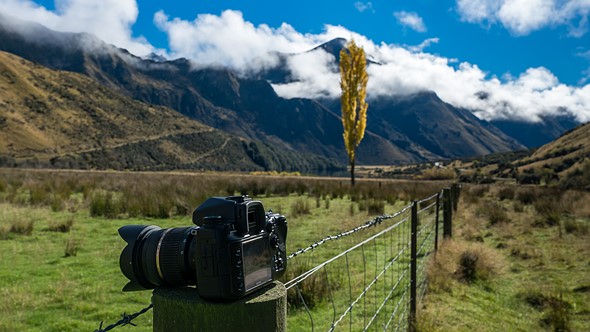 lonewolf1983-camera-on-fence-post-farming-mountain-backdrop