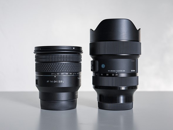 two black lenses stand upright on a white table
