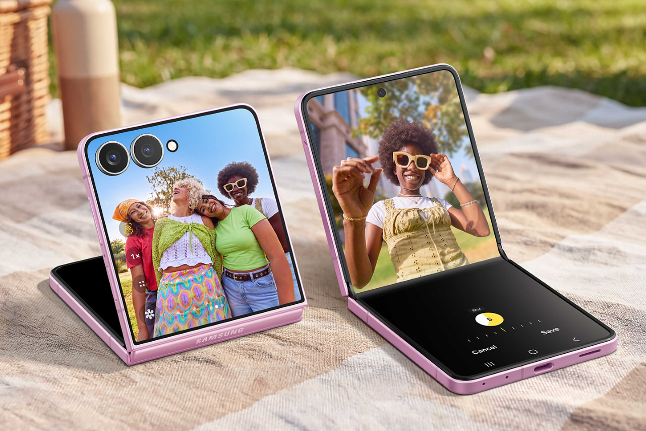 Two pink Samsung Galaxy Z Flip 8 folding phones on a table, displaying some of the different camera modes.