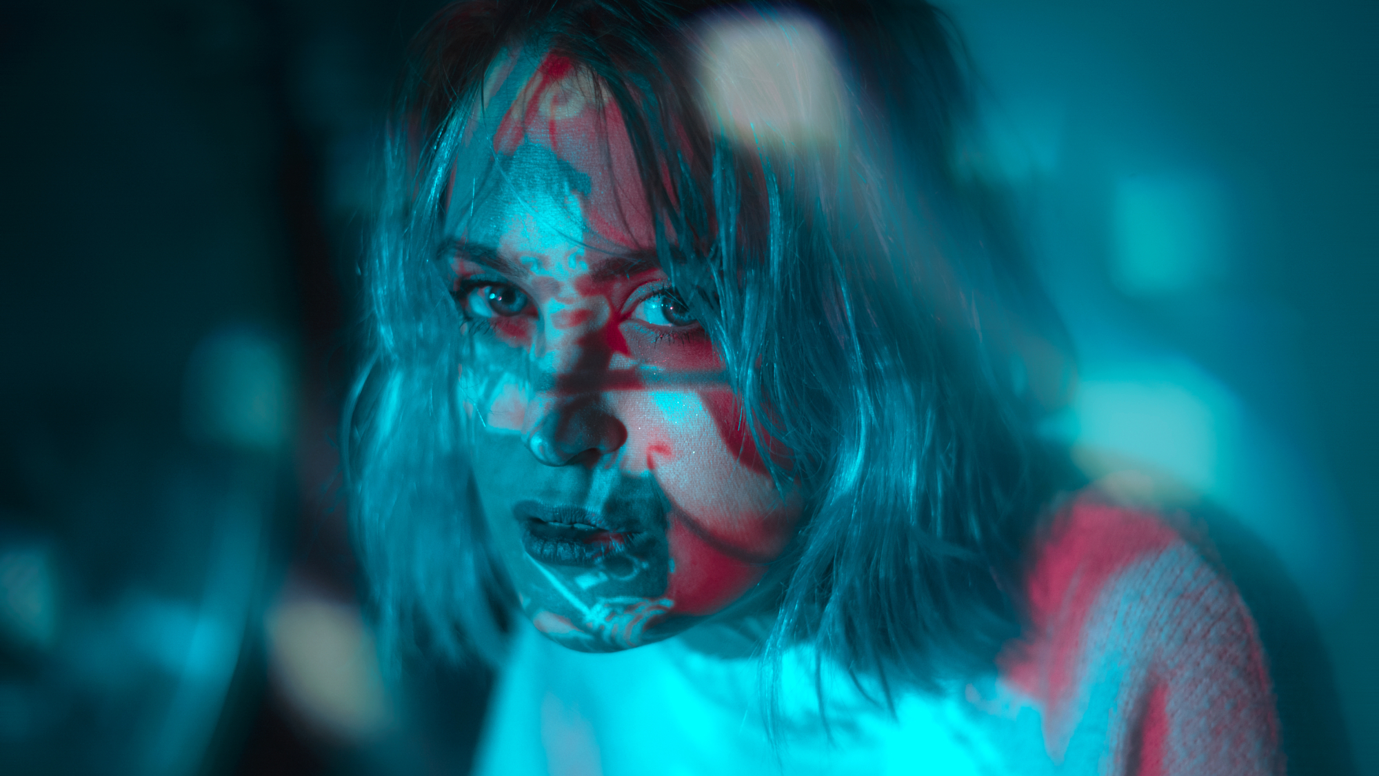Experimental editorial portrait lighting by Micaela Belgiorno featuring vibrant blue and magenta gel light projections.
